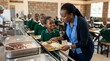 © SAHEED - African school children receiving healthy lunch from teacher in cafeteria canteen.