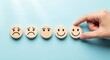 © CRACK - Customer satisfaction rating concept with wooden emoticon faces