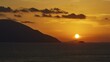 © Ralf Adler/imageBROKER - Still life of a sunset over the sea with mountains on the horizon and a sky in yellow and orange, sunset, Kassos, Karpathos, offshore islands, Dodecanese, Greek Islands, Greece