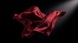 © AdPremium - Elegant red silk fabric floating in motion against a black background with dramatic lighting