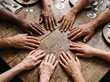 © AdPremium - Multi-ethnic and multi-generational hands form a circle on a rustic wooden table, symbolizing unity and family connection