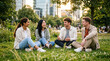 © Creative Valley - Happy group of young friends sitting together on a picnic blanket in a sunny park, celebrating laughter, meaningful conversations, togetherness, trust, lasting memories and Friendship Day