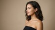 © Von - A beautiful woman with wavy dark hair gazes slightly to the side. She wears a black strapless top and has a natural makeup look.
