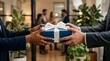 © SUMONAKTER - Diverse business partners exchanging a gift box in open office.