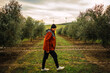 © Nazareno - Man walking through olive grove towards wind turbines