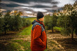 © Nazareno - Farmer contemplating olive grove during cloudy weather