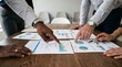 © tulusyhz - Diverse Professional Team Analyzing Financial Growth Charts and Marketing Data Reports During a Collaborative Strategic Office Meeting