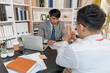 © Chadaporn - Business professionals discussing ideas and management approaches during a meeting, focusing on collaboration, problem solving, and decision making to improve workflow and organizational performance.
