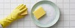 © heerim studio - Gloved Hand and Sponge Clean Plate with Suds on White Tile Background