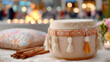 ©  VladaToday - Punjabi dhol drum resting on a rug near a bonfire with cushions and cinnamon sticks for cultural festival background and banner design