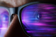 © Westend61 - Woman wears smart glass reflecting bright neon cyberspace light