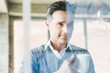 © Westend61 - Businessman looking at transparant projection screen in office