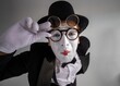 © Nomad_Soul - Close up of a funny male mime peering through double glasses