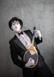 © Nomad_Soul - Funny male mime holding a tennis racket like a guitar