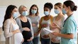 © JohnLee - Expectant mothers attending childbirth preparation course with masked midwife in modern maternity education center.