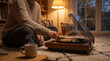 © Emre Akkoyun - Woman enjoying evening relaxation, playing vinyl record on turntable at home, cozy hygge lifestyle moment