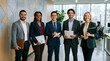 © MAHFUJ MONDOL - Group of diverse professional business people standing together in a modern office