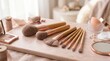 © Aqua - Makeup artist arranging brushes and products on a wooden board indoors