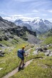 © Moritz Wolf/imageBROKER - Mountaineer on hiking trail in mountain landscape, descent at Col du Louvie, view of the summit of the Grand Combine, Valais Alps, Val de Bagnes, Valais, Switzerland