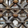 © Olesya - Seamless pattern of antique metal fence with rusty texture. Iron grid with cross shape geometric ornament. Industrial architectural detail of aged gate for construction and design.
