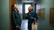 © Andrei Burakov - Senior woman chatting with younger woman in apartment hallway