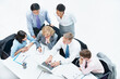 © peopleimages.com - Above, people and typing on laptop in conference room, finance team and budget overview discussion. Group, collaboration or paperwork with pc for financial plan, revenue or expenses agenda in meeting