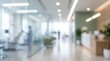 © Rajanikant - blurred abstract interior of modern medical clinic reception area, glass partitions, bright natural light, minimalist healthcare facility design, professional office lobby.