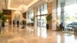 © Rajnikant - blurred interior of a luxury hotel lobby featuring high ceilings, warm lighting, and guest silhouettes.