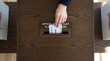 © Wekosinggi - Hand casting a vote into ballot box at polling station, election day, democracy concept