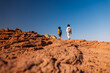© zhukovvvlad - Two active backpackers stroll through the desert against a blue sky. Mother and child on a hike. Summer camp. Timna National Park. The child is actively spending time.