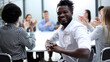 © Katsiaryna - Businesspeople laughing together during a meeting in an office