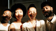 © Nastassia - Group of four diverse friends with natural hairstyles posing together in sunlight, shadows creating striking patterns on their faces and a modern interior background with blinds