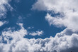 © Stephan - Dramatic view of fluffy white cumulus clouds billowing against a deep blue sky background