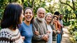 © TheseusStock - Happy multi-generational diverse group smiling together in a green park