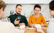 © JackF - Cheerful friendly company of men and women sitting at kitchen table and enjoying the poker game. Friends play a card game at home. Evening entertainment concept