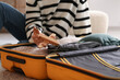 © Pixel-Shot - Young man with wooden plane and suitcase sitting on floor, closeup