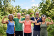 © Meow Creations - Diverse group of cheerful seniors flexing arm muscles in sunny park