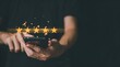 © Mayla - Businessman customer reviews 5 Stars with smartphone. Customer service evaluation and satisfaction. Top service, ISO certification, Guarantee, Quality assurance.