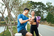 © PaeGAG - Asian couple checking fitness data on smartwatch after exercise