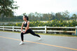 © PaeGAG - Young asian woman stretching legs warming up for outdoor exercise