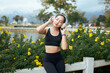 © PaeGAG - Woman enjoying music outdoors in sportswear feeling relaxed