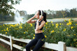© PaeGAG - Young woman enjoying music outdoors listening headphones