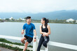 © PaeGAG - Young couple resting after exercising, staying hydrated