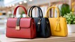 © kardaska - Three colorful leather handbags sitting on wooden surface