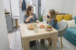 © artmim - Pretty child and mother eating pizza at home