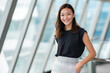 © PicStudio - Young attractive Asian corporate manager, elegant skirt, executive brainstorming workshop, inspired employees, leadership impact, premium office portrait.