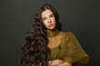 © millaf (Nemchinova) - Young long hair woman classic hairs curly. Brunette model with wavy hair looking at camera
