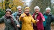 © Harry - A group of senior women laughing and having fun together in a park during autumn