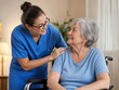 © RONY - Professional nurse in scrubs providing caring support to an elderly woman sitting in a wheelchair