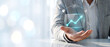 © ViewStocks - Businessman holding virtual screen with growing line graph and business analytics icons